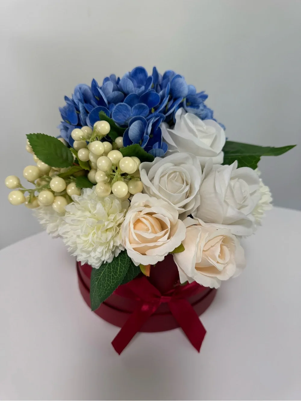 Artificial Floral Arrangement in Blue and Cream with Red Box